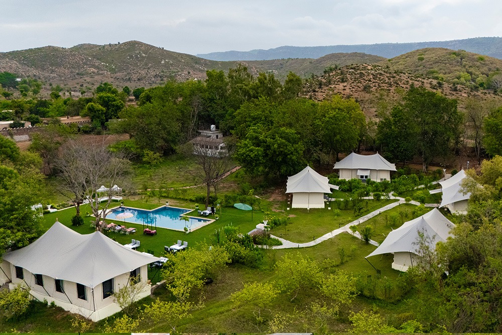 Luxury tent resort amid green hills